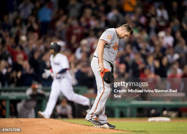 Alex Asher of the Baltimore Orioles reacts after allowing a home run to Hanley Ramirez of the Boston Red Sox in the sixth inning at Fenway Park on...