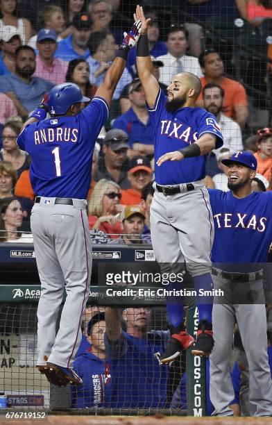 Elvis Andrus of the Texas Rangers celebrates his solo home run with teammate Rougned Odor during the fourth inning against the Houston Astros at...
