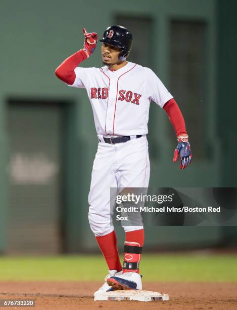 Mookie Betts of the Boston Red Sox reacts after a two-run double against the Baltimore Orioles in the seventh inning at Fenway Park on May 2, 2017 in...