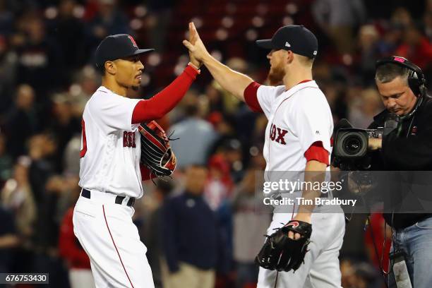 Mookie Betts celebrates with Craig Kimbrel of the Boston Red Sox after defeating the Baltimore Orioles 5-2 at Fenway Park on May 2, 2017 in Boston,...