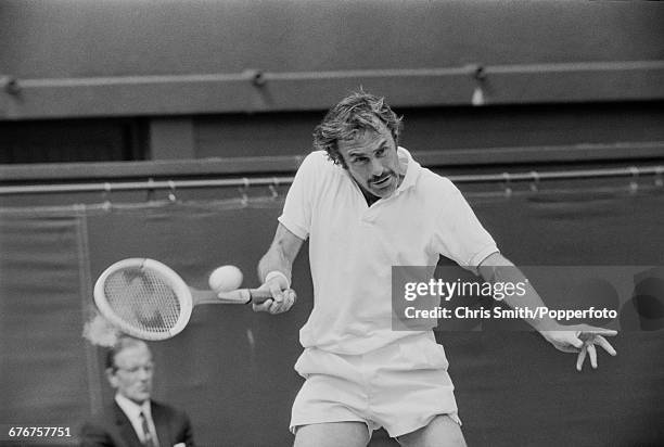 Australian tennis player John Newcombe pictured in action competing to win the final of the Men's Singles tournament against American tennis player...
