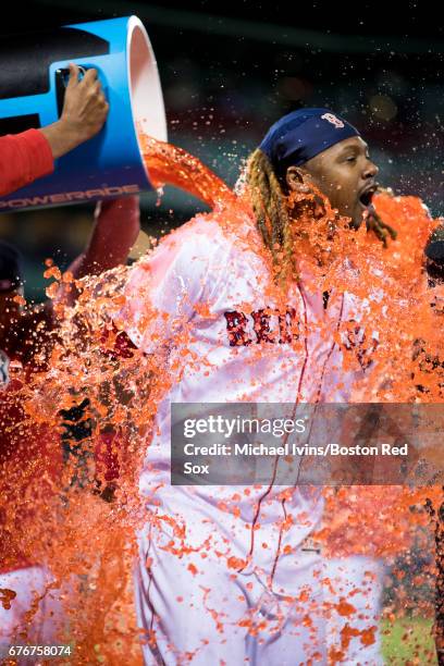 Hanley Ramirez of the Boston Red Sox gets doused by teammates after his two home run game led the team to a 5-2 win over the Baltimore Orioles at...