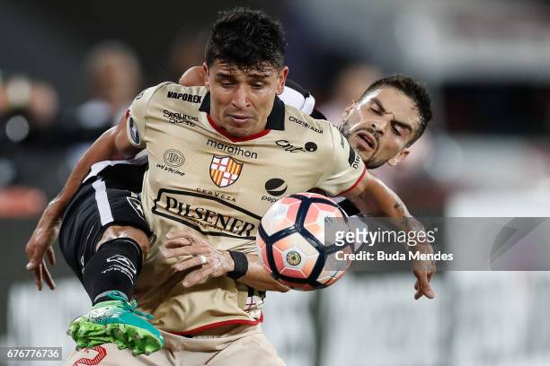 Rodrigo Pimpao of Botafogo struggles for the ball with Mario Pineida of Barcelona de Guayaquil during a match between Botafogo and Barcelona de...