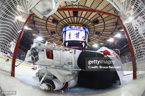 Craig Anderson of the Ottawa Senators lies in the net following a first-period goal by Michael Grabner of the New York Rangers in Game Three of the...