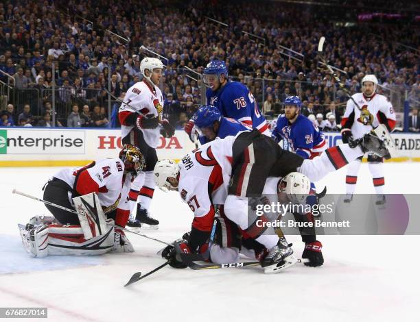 Ben Harpur of the Ottawa Senators tumbles over Cody in Game Three of the Eastern Conference Second Round during the 2017 NHL Stanley Cup Playoffs at...