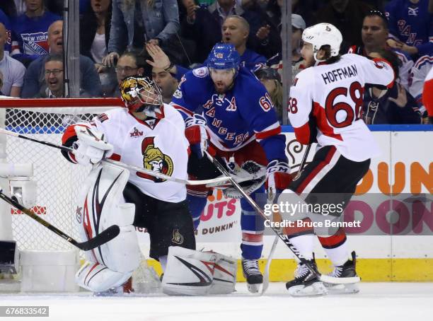 Craig Anderson of the Ottawa Senators and Mike Hoffman defend against Rick Nash of the New York Rangers during the third period in Game Three of the...