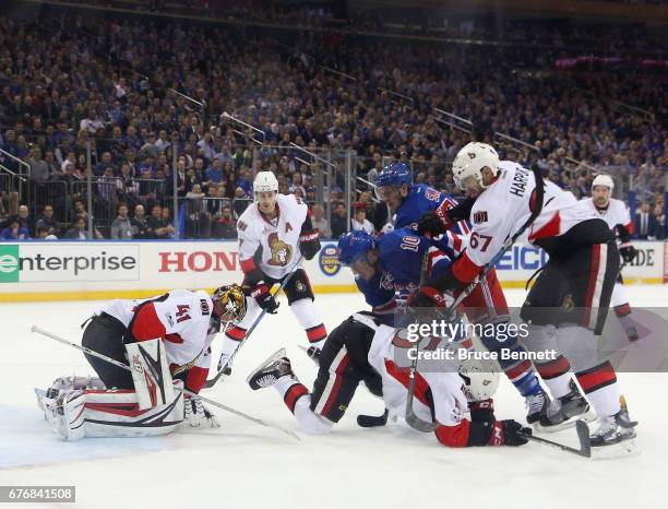 Miller of the New York Rangers is checked by Ben Harpur of the Ottawa Senators in Game Three of the Eastern Conference Second Round during the 2017...