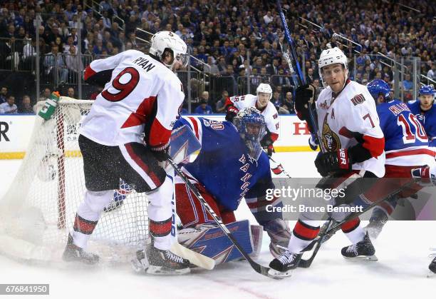 Henrik Lundqvist of the New York Rangers defends against Bobby Ryan and Kyle Turris of the Ottawa Senators in Game Three of the Eastern Conference...