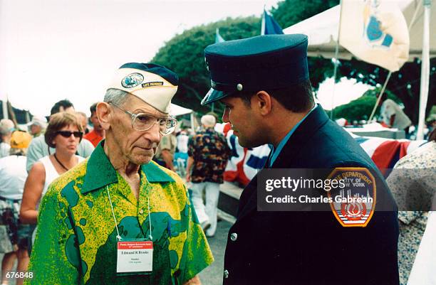Edmund Brooks , a veteran of the attack on Pearl Harbor speaks with New York City firefighter Luis Torres at the 60th Anniversary of the attack on...