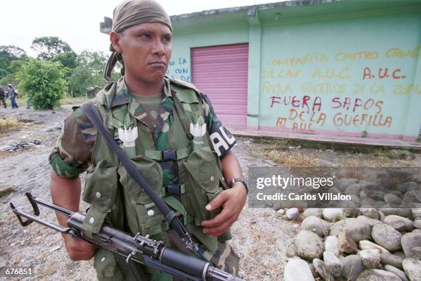 Paramilitary soldier patrols the streets December 14, 2000 in San Isidro, in the Guamuez Valley, Colombia.