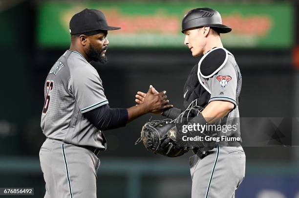 Fernando Rodney of the Arizona Diamondbacks celebrates with Chris Herrmann after a 6-3 victory against the Washington Nationals at Nationals Park on...