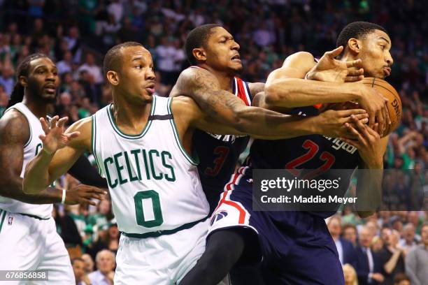 Avery Bradley of the Boston Celtics, Bradley Beal and Otto Porter Jr. #22 of the Washington Wizards battle for a rebound during the fourth quarter of...