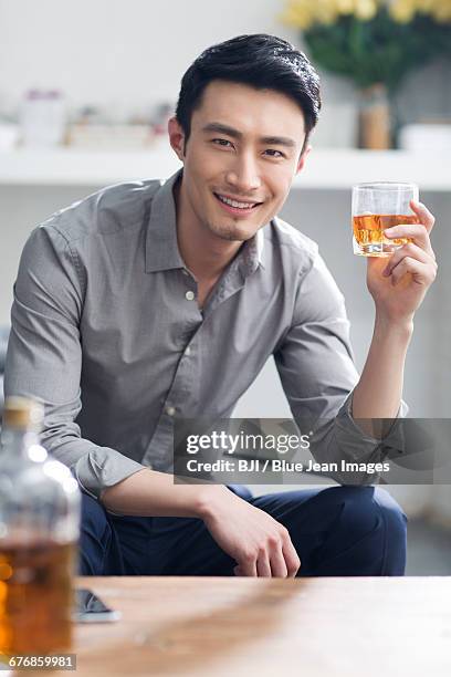 young man enjoying fine wine - china u s strategic and economic dialogues helds in beijing fotografías e imágenes de stock