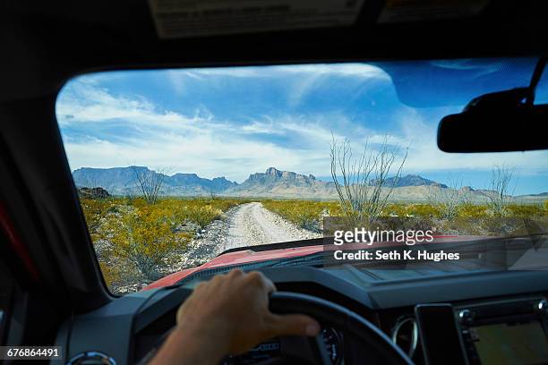 man driving off road vehicle along dirt track, big bend national park, texas, usa - chisos mountains stockfoto's en -beelden