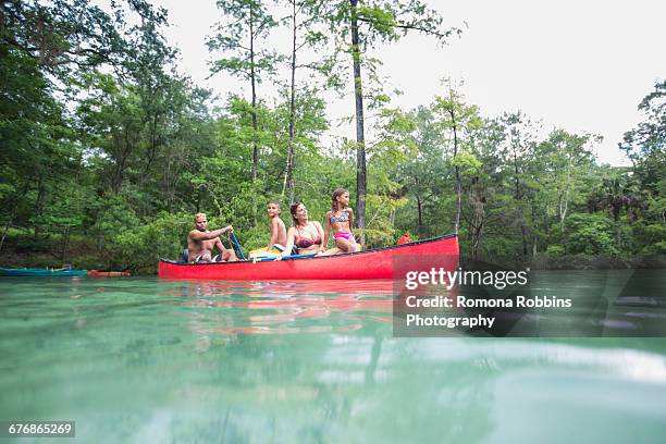 family on a canoe trip together at econfina spring, florida, usa - family red canoe stock pictures, royalty-free photos & images