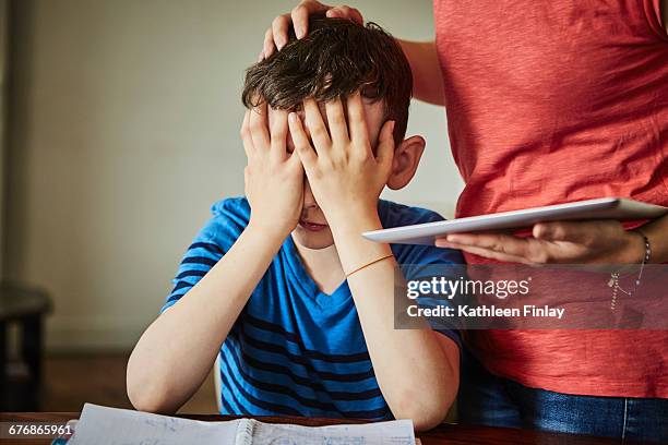 mother comforting upset son doing homework - frustrated parent stock pictures, royalty-free photos & images