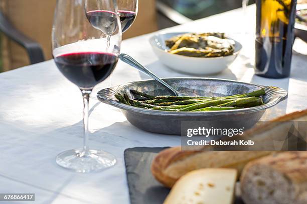 party garden table with red wine, cheese board and green beans - los angeles garden party stock pictures, royalty-free photos & images