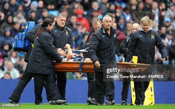 Newcastle United's Hatem Ben Arfa receives oxygen on the stretcher after being injured by a tackle from Manchester City's Nigel De Jong