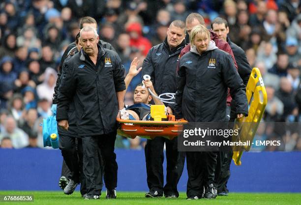 Newcastle United's Hatem Ben Arfa acknowledges the crowd as he is stetchered off the pitch due to being injured by a tackle from Manchester City's...