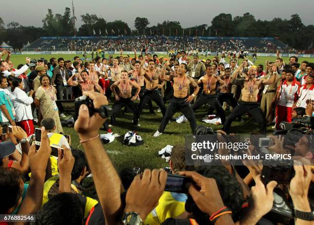 New Zealand players perform a haka as they celebrate winning gold in the Rugby 7's on day nine of the 2010 Commonwealth Games at the Delhi University...