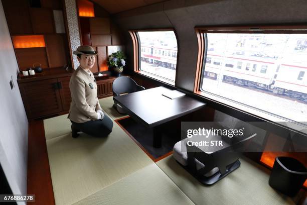This picture taken on April 26, 2017 shows a crew member introducing the Shiki-Shima Suite of the Train Suite Shiki-Shima, operated by East Japan...