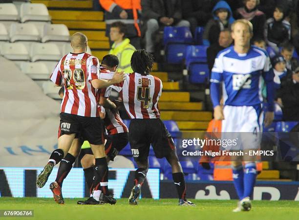 Brentford's Sam Wood is congratulated by his team mates after scoring the first goal as Birmingham City's Lee Bowyer walks by dejected