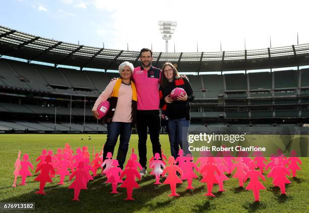 Jordan Lewis of the Demons poses with cancer survivors Fran Coslovich and Kim Wood during a Melbourne Demons Pink Lady AFL match media opportunity at...