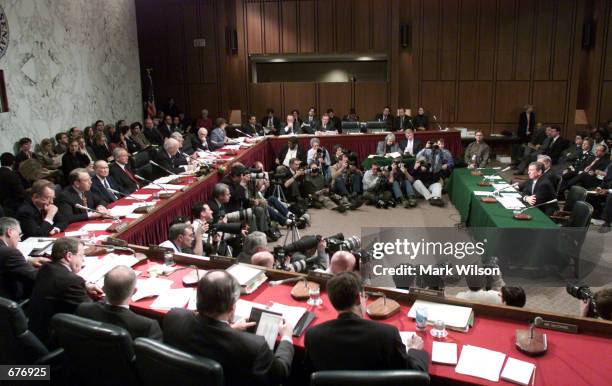 Attorney General-designee John Ashcroft, right, listens to opening remarks during his comfirmation hearing before the Senate Judiciary Committee...