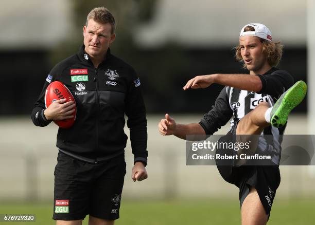 Magpies head coach Nathan Buckley speaks to Tim Broomhead during a Collingwood Magpies AFL training session at Olympic Park on May 3, 2017 in...