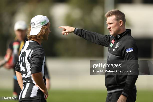 Magpies head coach Nathan Buckley speaks to Tim Broomhead during a Collingwood Magpies AFL training session at Olympic Park on May 3, 2017 in...