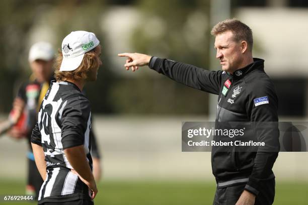 Magpies head coach Nathan Buckley speaks to Tim Broomhead during a Collingwood Magpies AFL training session at Olympic Park on May 3, 2017 in...