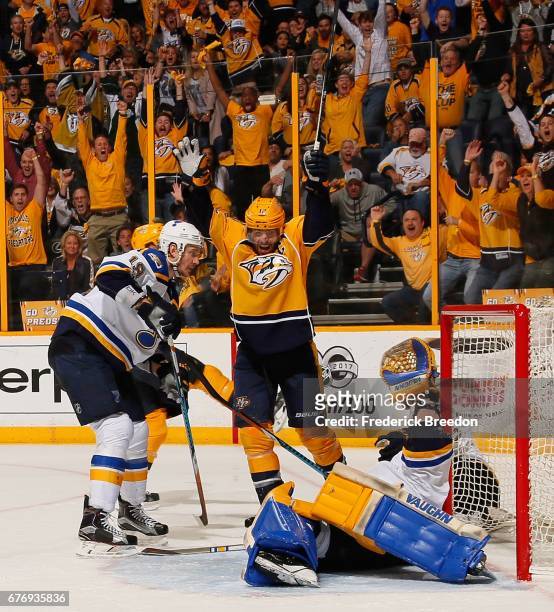 Jay Bouwmeester of the St. Louis Blues watches Mike Fisher of the Nashville Predators celebrate after a goal against goalie Jake Allen during the...