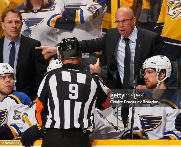 Head coach Mike Yeo of the St. Louis Blues talks to a referee after a penalty was called favoring the Nashville Predators during the third period of...