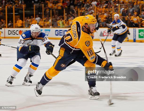 David Perron of the St. Louis Blues chases Colton Sissons of the Nashville Predators as he fires a shot during the third period of Game Four of the...