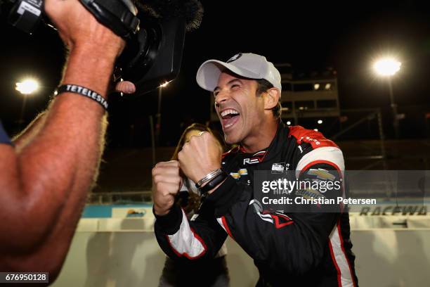 Helio Castroneves of Brazil, driver of the Team Penske Chevrolet celebrates after winning the Verizon P1 Pole Award for the Desert Diamond West...