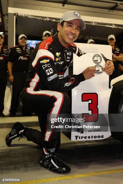 Helio Castroneves of Brazil, driver of the Team Penske Chevrolet celebrates after winning the Verizon P1 Pole Award for the Desert Diamond West...