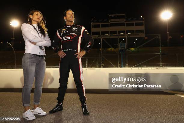 Helio Castroneves of Brazil, driver of the Team Penske Chevrolet stands on the grid with girlfriend Adriana Henao after qualifying for the Desert...