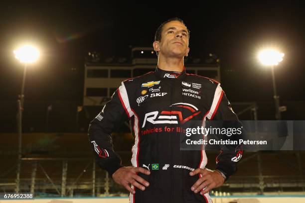 Helio Castroneves of Brazil, driver of the Team Penske Chevrolet stands on the grid after qualifying for the Desert Diamond West Valley Phoenix Grand...