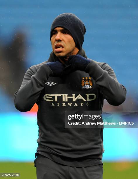 Manchester City's Carlos Tevez adjusts his snood before kick off