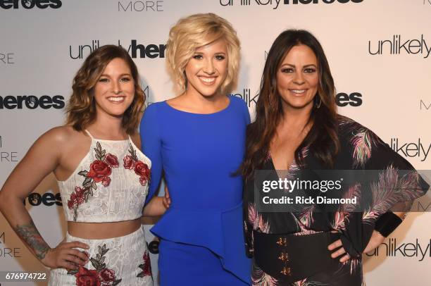 Singer-songwriter Cassadee Pope, actress Savannah Chrisley and singer-songwriter Sara Evans take photos on carpet for Unlikely Heroes hosts, Night of...