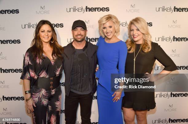 Singer-songwriter Sara Evans, CMT Host Cody Alan, actress Savannah Chrisley and Founder and CEO of Unlikely Heroes Erica Greve take photos on carpet...