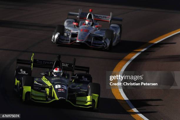 Charlie Kimball, driver of the Chip Ganassi Racing Honda leads Will Power of Australia, driver of the Team Penske Chevrolet during practice for the...