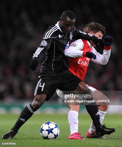 Partizan Belgrade's Mohamed Kamara and Arsenal's Andrey Arshavin battle for the ball