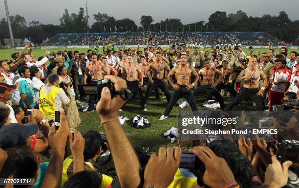 New Zealand players perform a haka in front of fans as they celebrate winning gold in the Rugby Sevens