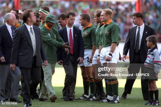 South Africa President Nelson Mandela, third left, is introduced to the South African rugby union team, including captain Francois Pienaar, third...