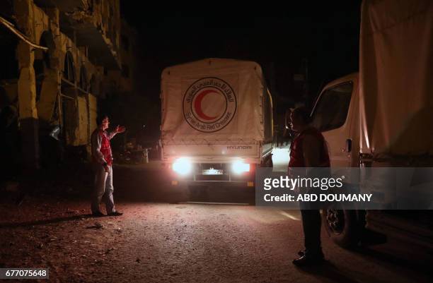Syrian Arab Red Crescent truck part of a SARC and UN aid convoy prepare to unload supplies in the rebel-held town of Douma, on the eastern outskirts...