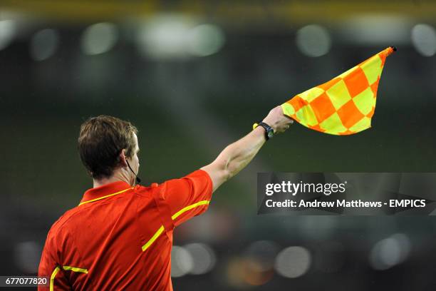 An assistant referee flags for offside