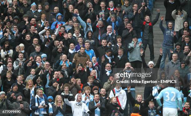 Manchester City fans cheer Carlos Tevez as he prepares to take a corner