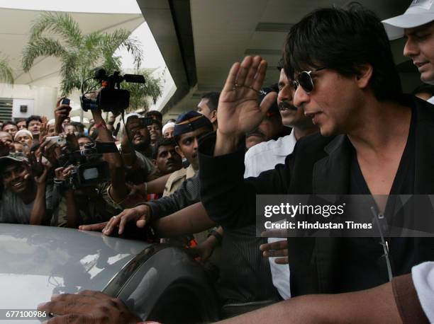 Bollywood star Shah Rukh Khan waves upon his arrival from the U.S. At the Mumbai international airport August 18, 2009. Khan one of India's best...