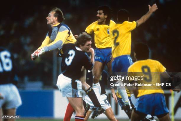 Scotland goalkeeper Jim Leighton punches clear of team mates Roy Aitken and Murdo MacLeod as well as Brazil's Ricardo Rocha, Jorginho and Careca.